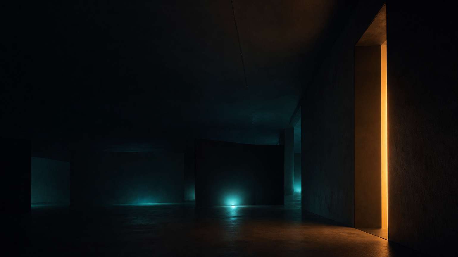Atmospheric view of a dark spatial installation with cyan and amber light